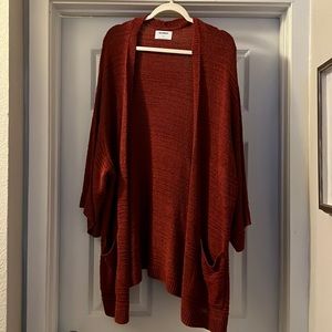 Burnt orange cardigan.